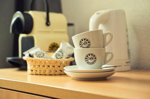 three coffee cups sitting on top of a counter at Bed & Breakfast at Urnersee Winter Edition in Seedorf