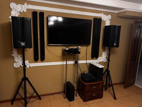 a flat screen tv on a wall with speakers at Sky luxe-hotel Astana in Astana
