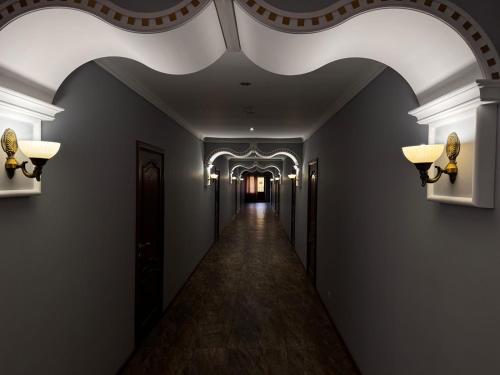 a hallway in a building with a ceiling and lights at Sky luxe-hotel Astana in Astana