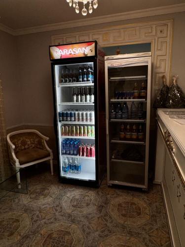 a refrigerator filled with lots of bottles of soda at Sky luxe-hotel Astana in Astana