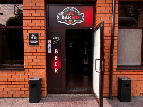 an open door to a bar on a brick building at Sky luxe-hotel Astana in Astana