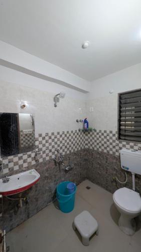 a bathroom with a sink and a toilet in it at Jalsa Home Stay in Sheoganj