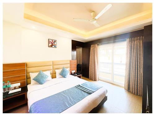 a bedroom with a large bed and a window at Sea View Hotel Golden Palace Rivera Puri in Puri