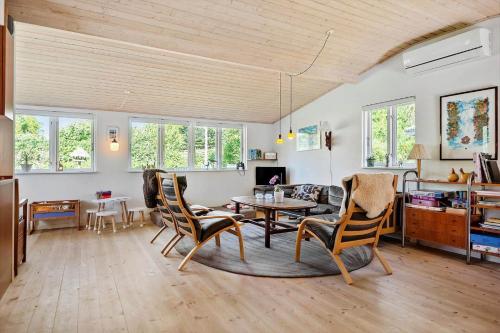a living room with a table and chairs at 30383-Odder-Lyngbakkevej-10 in Odder