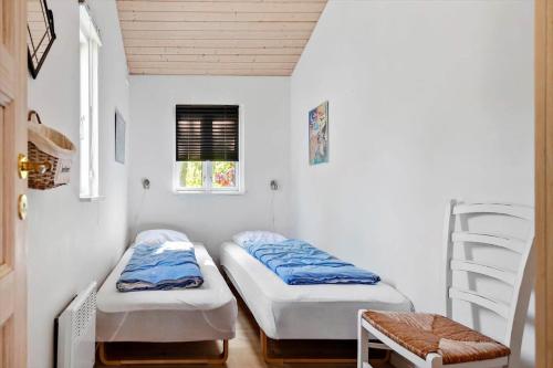 two beds in a small room with a ladder at 30383-Odder-Lyngbakkevej-10 in Odder