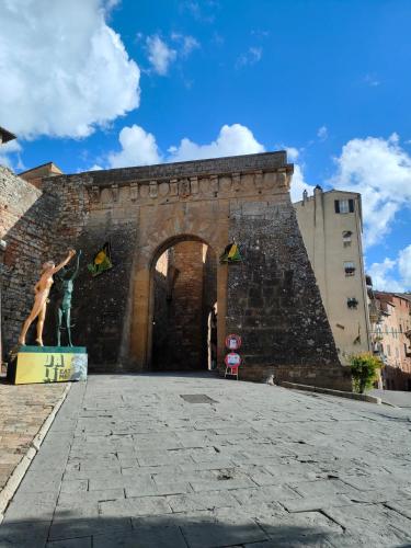 a building with a statue in front of it at Ciliano 16 in Montepulciano