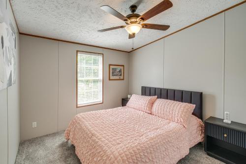 a bedroom with a bed and a ceiling fan at 1 Mi to Geneva SP Family Home with Game Room and Yard in Geneva