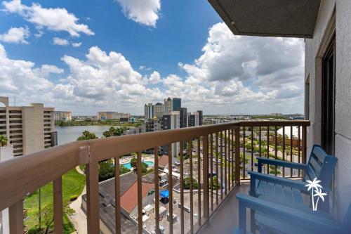 a balcony with a blue bench and a view of a city at Lake View Top Floor 2 Bed 2 Bath Condo with Balcony in Orlando