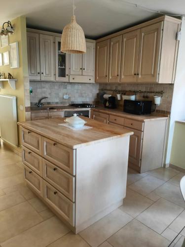 a kitchen with wooden cabinets and a kitchen island at Ciliano 16 in Montepulciano
