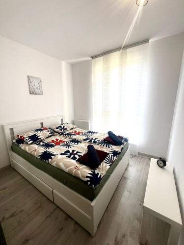 a bedroom with a bed and a window at Apartament Nasypowa 3 in Gdynia