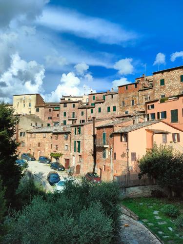 a large building with cars parked in front of it at Ciliano 16 in Montepulciano