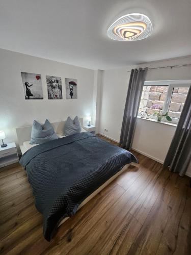 a bedroom with a large bed and a window at Luna Apartment in Dinkelsbühl