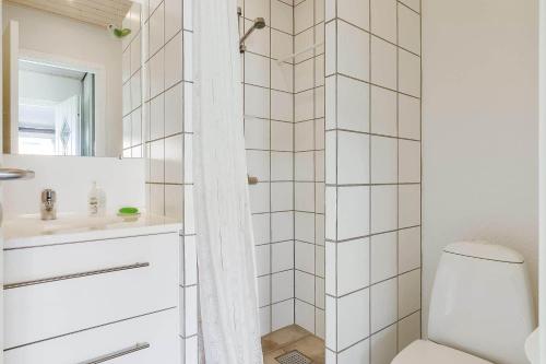 a white bathroom with a toilet and a sink at 40128-Juelsminde-Strandengen-41 in Juelsminde
