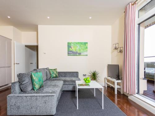 a living room with a couch and a tv at Penthouse-Uk36400 in Ashford