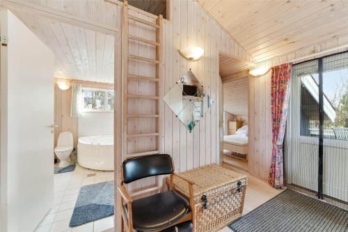 a small room with a chair and a bedroom at 30035-Malling-Pilelokken-16 in Malling