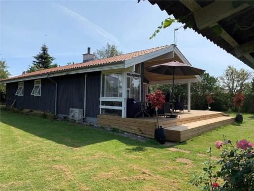 a house with a deck and an umbrella at 30035-Malling-Pilelokken-16 in Malling