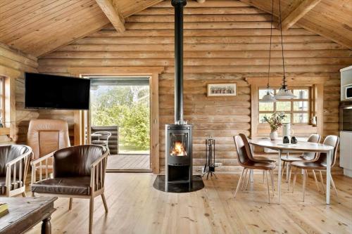 a living room with a fireplace in a log cabin at 30118-Odder-Pouli-Nielsensvej-27 in Beder
