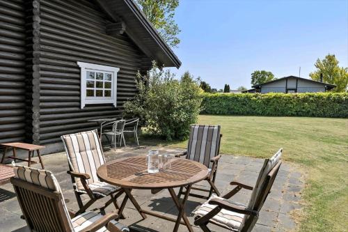 a wooden table and chairs on a patio at 30118-Odder-Pouli-Nielsensvej-27 in Beder