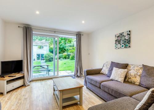 a living room with a couch and a tv at Atlantic Reach Holiday Village in Newquay