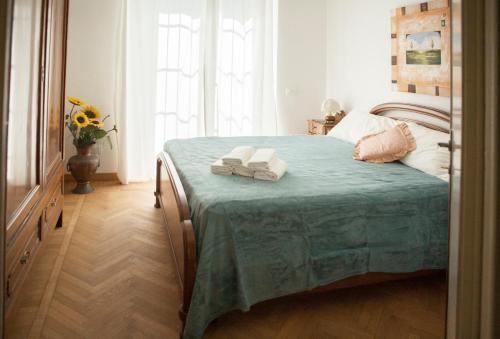 a bedroom with a bed with two towels on it at Villa Giove Rooms in Prato