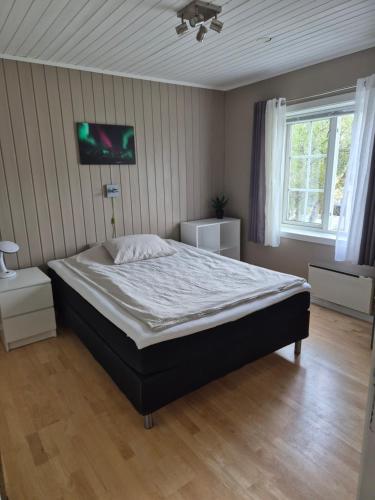 a bedroom with a bed and a tv on the wall at Hybelleilighet - Privat - no parking in Tromsø