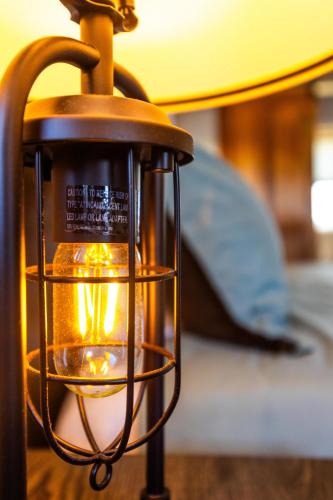 a lantern hanging from a table in front of a bed at Black Diamond By Masontyler in Davis