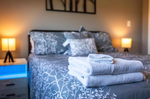 a bedroom with a bed with towels on it at Black Diamond By Masontyler in Davis