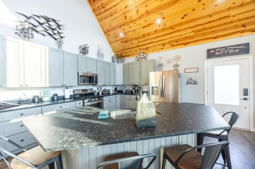a large kitchen with a counter top and a refrigerator at Black Diamond By Masontyler in Davis