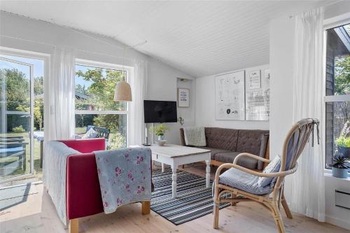 a living room with a couch and a table and chairs at 30038-Beder-Hogevaenget-15 in Beder