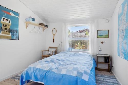 a bedroom with a blue bed and a window at 30038-Beder-Hogevaenget-15 in Beder