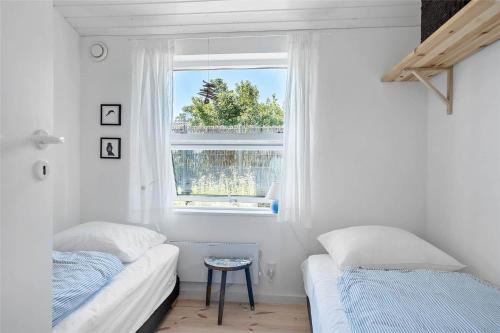 a bedroom with two beds and a window at 30038-Beder-Hogevaenget-15 in Beder