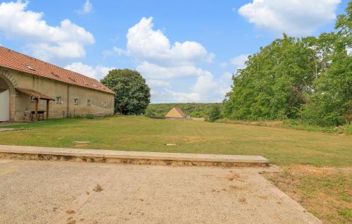 a large grassy field next to a building at 2 Bedroom Stunning Home In Monthenault in Monthenault