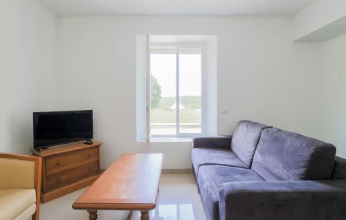 a living room with a blue couch and a table at 2 Bedroom Stunning Home In Monthenault in Monthenault
