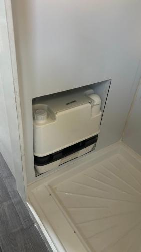 a drawer in a wall with a device in it at Camping car YALLAH TRIP in Agadir
