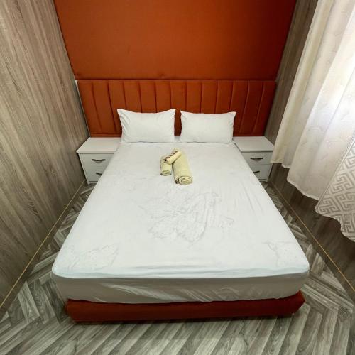 a bed with a phone sitting on top of it at Camping Riad Maissa in Dou Tourga