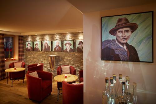 a restaurant with a painting of a man in a hat at Riffelhaus 1853 in Zermatt