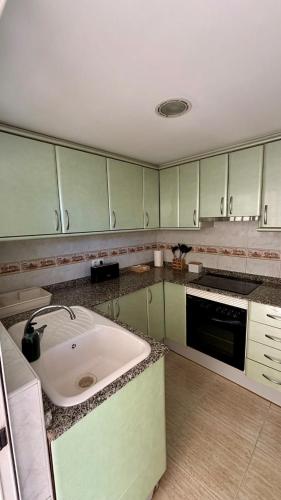 a kitchen with a large white sink in it at BeachFront Apartment in Gandia in Puerto de Gandía