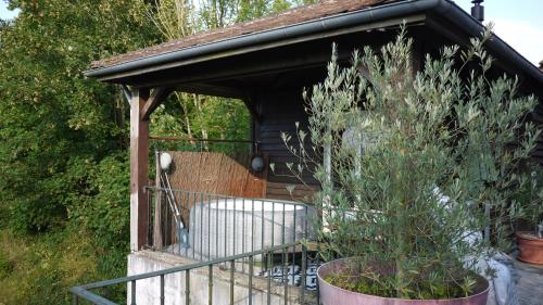 a gazebo with a chair and a plant at Gite pour se ressourcer in Liancourt-Saint-Pierre