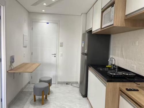 a kitchen with a sink and a counter top at Apto ao lado do metrô de SP in Sao Paulo