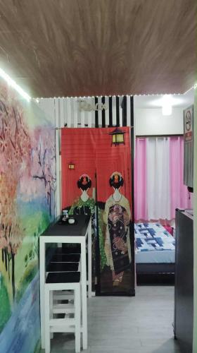 a room with a bedroom with a bed and a table at Staycation AMAIA SJDM in Tunkong Manga