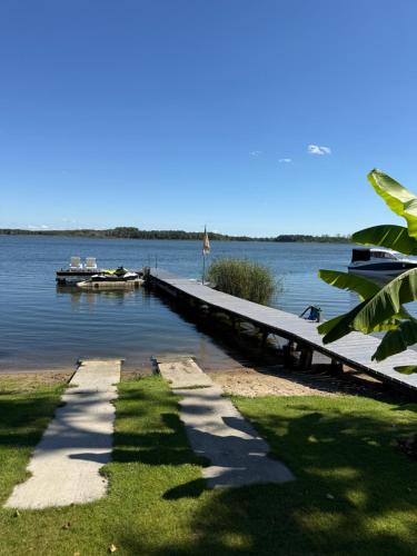 a dock on a lake with a boat in the water at BananaHouse in Kruszwin