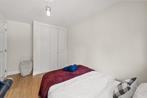 a bedroom with a bed with a blue towel on it at Polmont Haven: Spacious 4- Bedroom Retreat in Polmont
