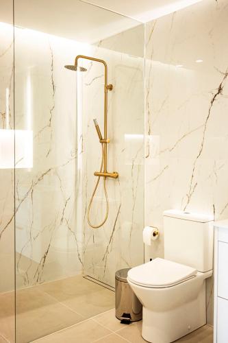 a bathroom with a toilet and a shower at Hidden Corner by Sabugo House in Ponta do Sol