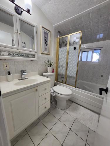 a bathroom with a toilet and a sink and a shower at 3Q Ltd in Hamilton