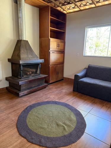 a living room with a couch and a fireplace at Fazenda Dos Milagres in Santana do Riacho
