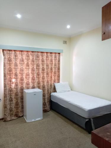 a bedroom with a bed and a window with at Beyond Expectation in Avondale