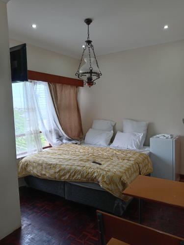 a bedroom with a bed and a chandelier at Beyond Expectation in Avondale