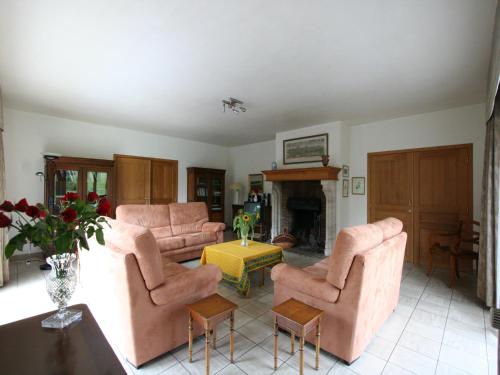 a living room with pink furniture and a fireplace at Cozy Holiday Home in Lesterny near Lake in Nassogne