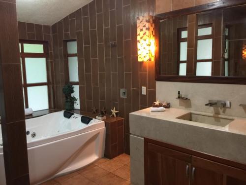 a large bathroom with a tub and a sink at Cabaña del RIO by Bellavista Cabañas in Mazamitla