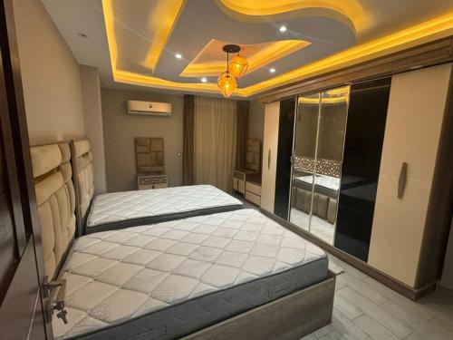 a bedroom with a large bed in a room at اكتوبر الحصري 6 October in 6th Of October